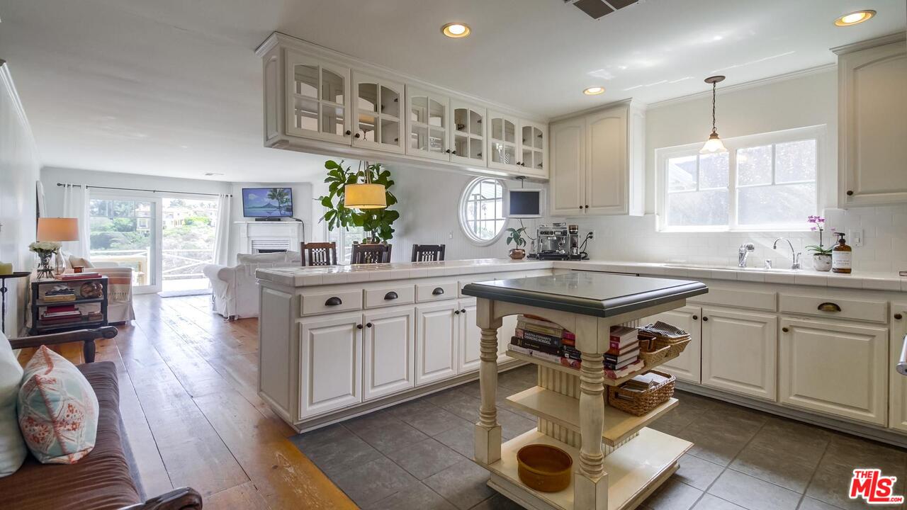 29500 Heathercliff Road, Unit 119 Malibu, CA 90265 - Photo 5 of 47 a kitchen with a sink stove and wooden floor