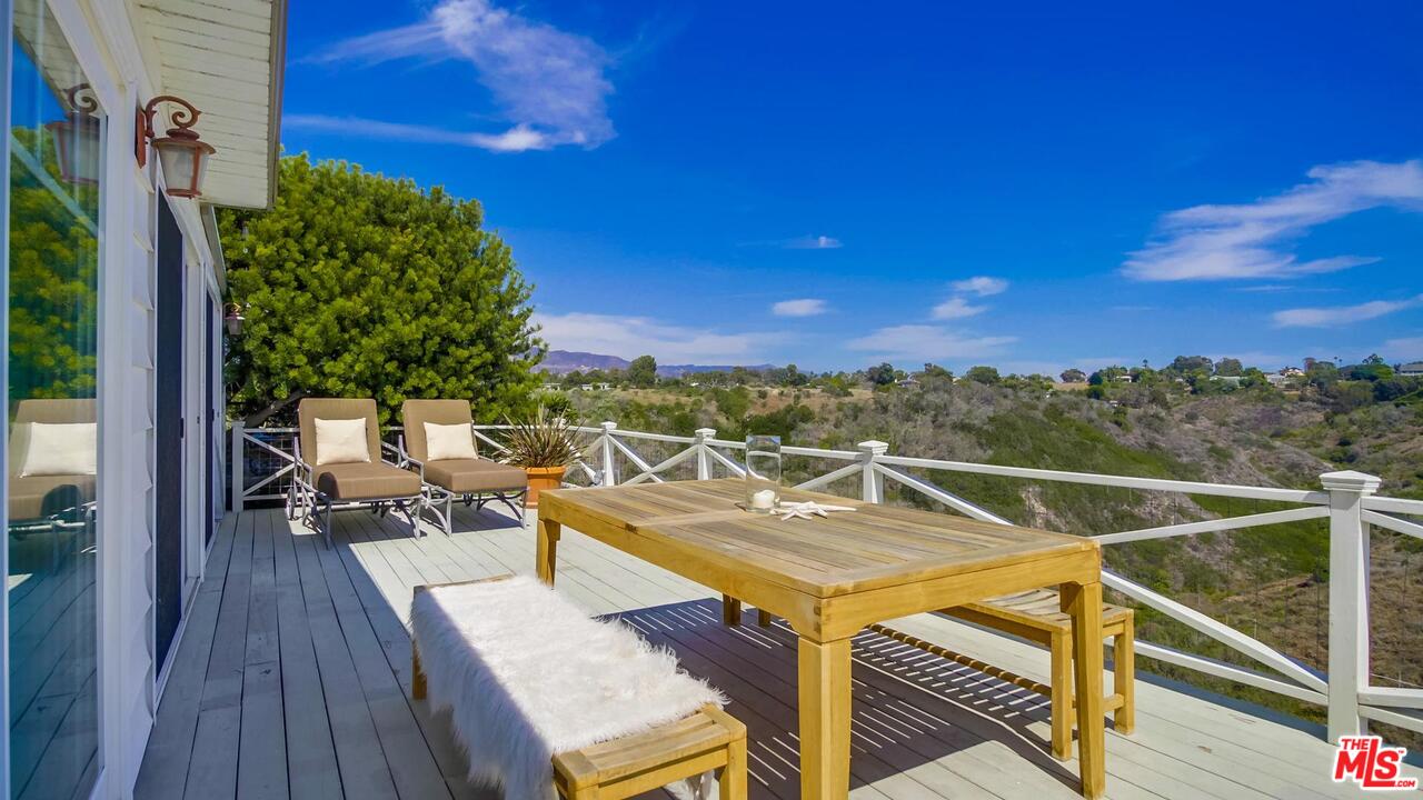 29500 Heathercliff Road, Unit 119 Malibu, CA 90265 - Photo 43 of 47 a view of a chairs and table in patio with a barbeque grill