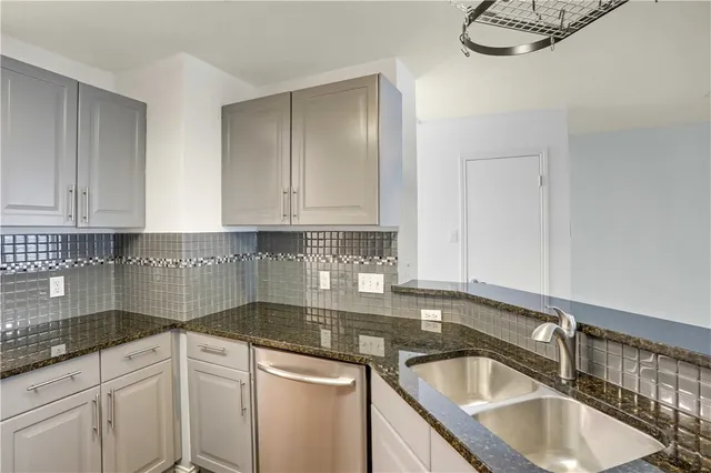 a kitchen with granite countertop a sink and cabinets