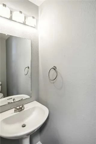 a bathroom with a sink a mirror and vanity