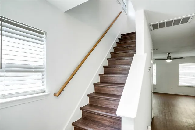 a view of staircase with white walls and windows