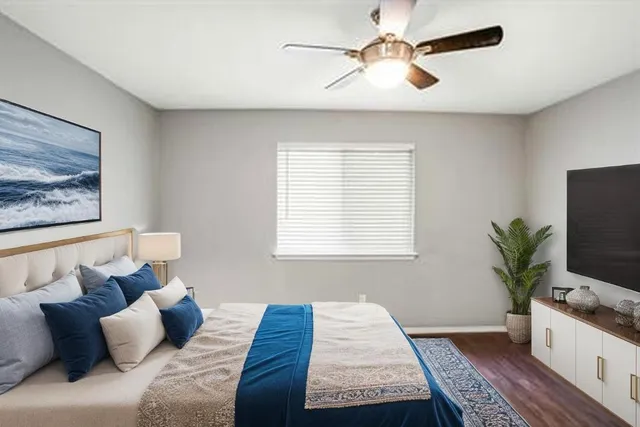 a bedroom with a large bed and a couch