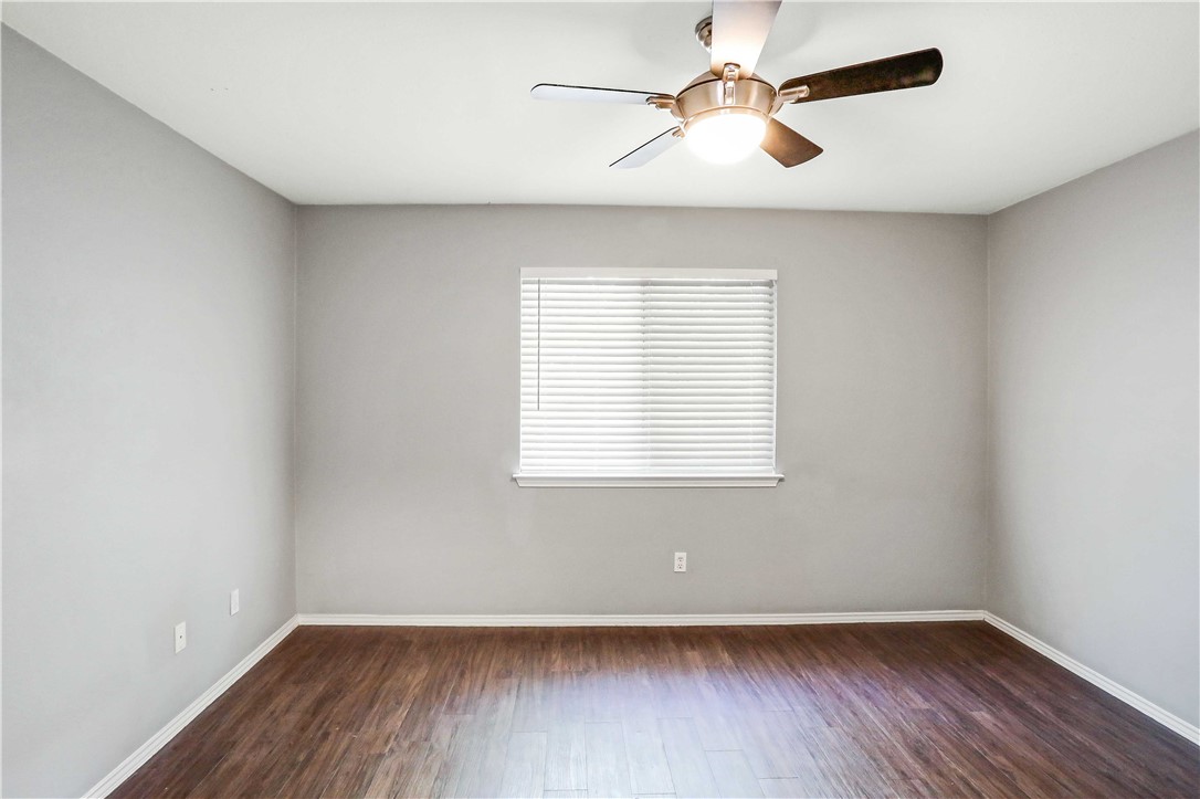 9614 Nightjar Drive, Unit A Austin, TX 78748 - Photo 21 of 34 an empty room with wooden floor and windows
