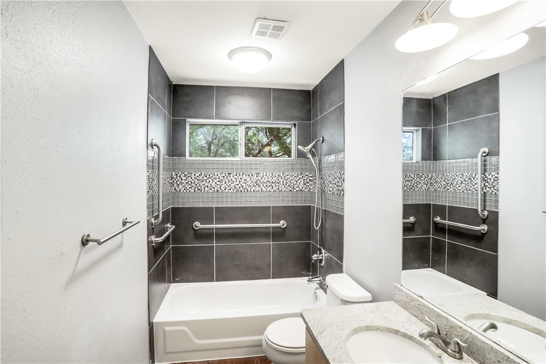 9614 Nightjar Drive, Unit A Austin, TX 78748 - Photo 23 of 34 a bathroom with a sink a toilet and shower