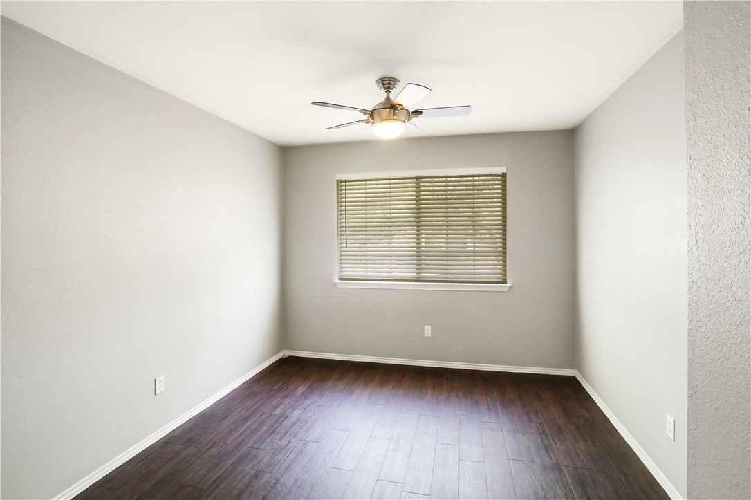 9614 Nightjar Drive, Unit A Austin, TX 78748 - Photo 25 of 34 an empty room with wooden floor and windows