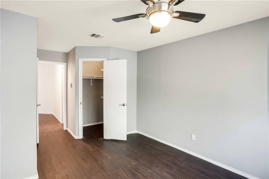 9614 Nightjar Drive, Unit A Austin, TX 78748 - Photo 26 of 34 an empty room with wooden floor chandelier fan and closet area