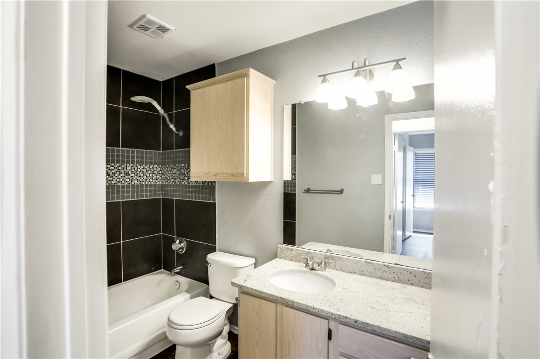 9614 Nightjar Drive, Unit A Austin, TX 78748 - Photo 28 of 34 a bathroom with a sink a toilet and shower