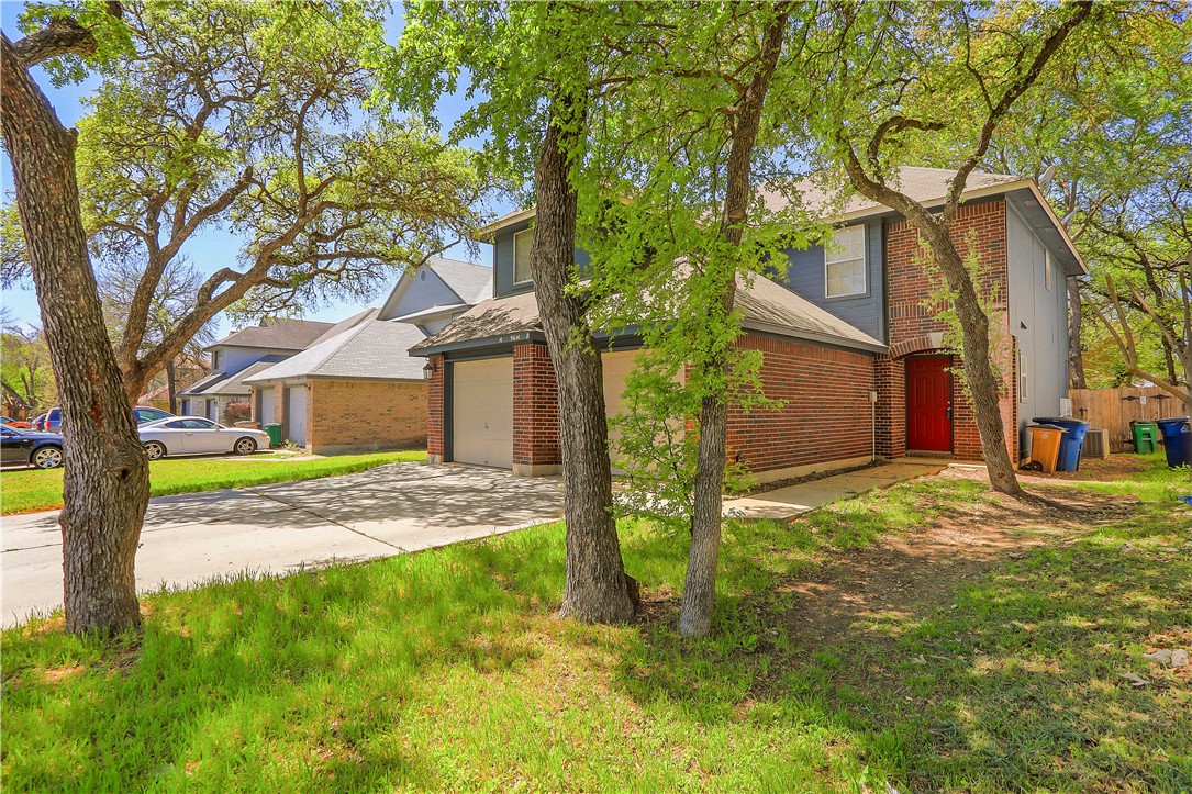 9614 Nightjar Drive, Unit A Austin, TX 78748 - Photo 3 of 34 a view of a yard in front of a house with large tree