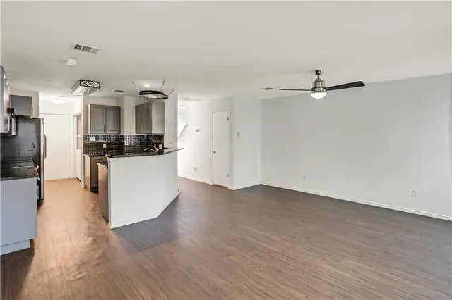 a view of a kitchen with cabinets and wooden floor