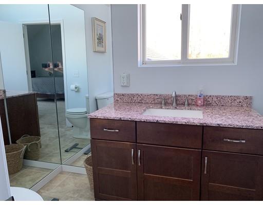 205 Podunk Road Sturbridge, MA 01566 - Photo 19 of 30 a bathroom with a granite countertop sink a toilet and a mirror