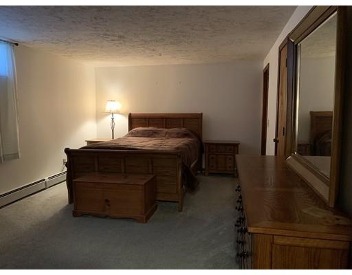 205 Podunk Road Sturbridge, MA 01566 - Photo 22 of 30 a room with a bed and a night stand