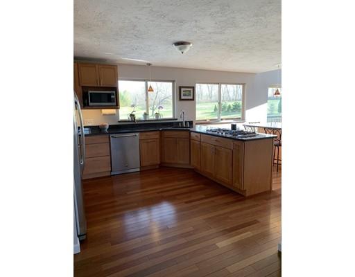 205 Podunk Road Sturbridge, MA 01566 - Photo 5 of 30 a kitchen with granite countertop stainless steel appliances and wooden cabinets
