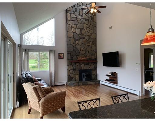 205 Podunk Road Sturbridge, MA 01566 - Photo 6 of 30 a living room with furniture a flat screen tv and a large window
