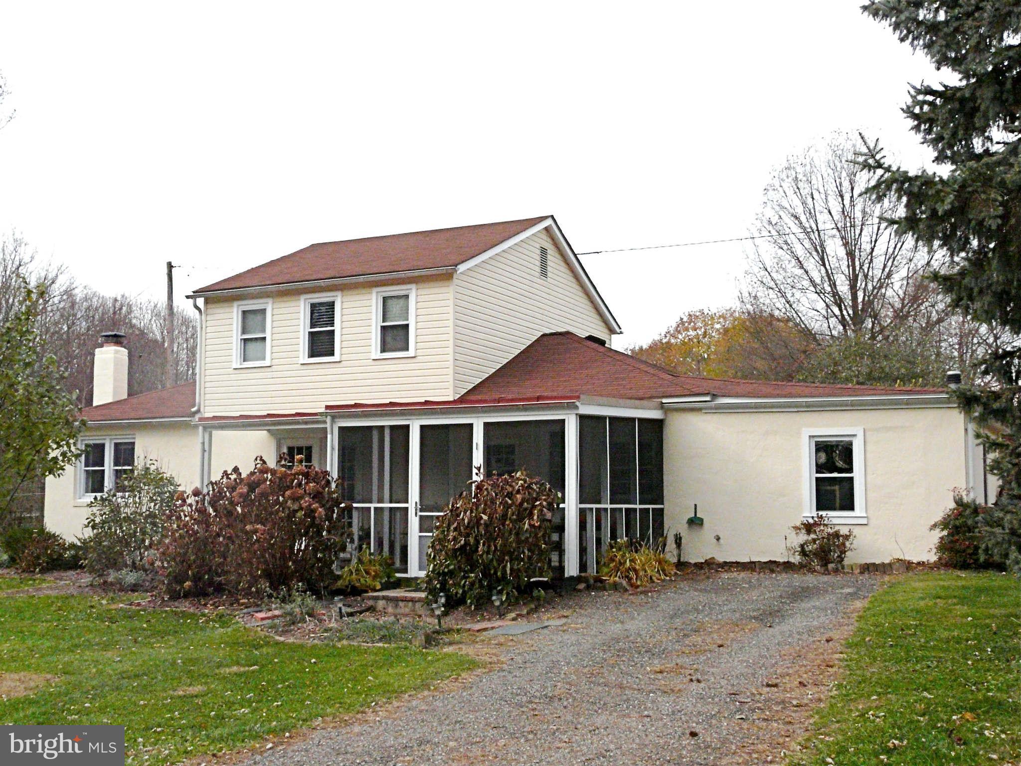 3009 Paper Mill Road Phoenix, MD 21131 - Photo 3 of 30 a front view of a house with a garden and porch
