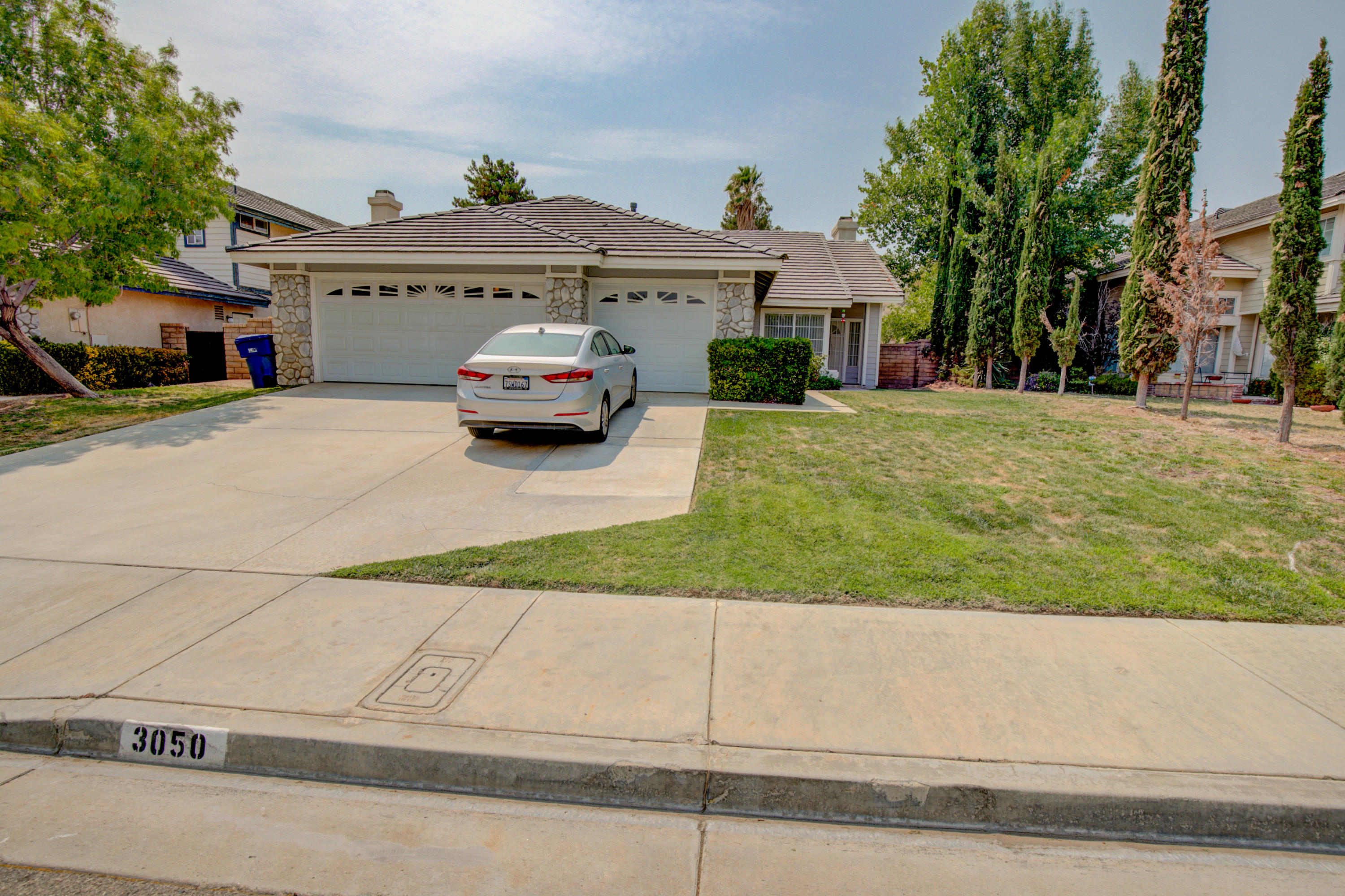 3050 Quarry Road Palmdale, CA 93550 - Photo 1 of 21 a front view of a house with a yard