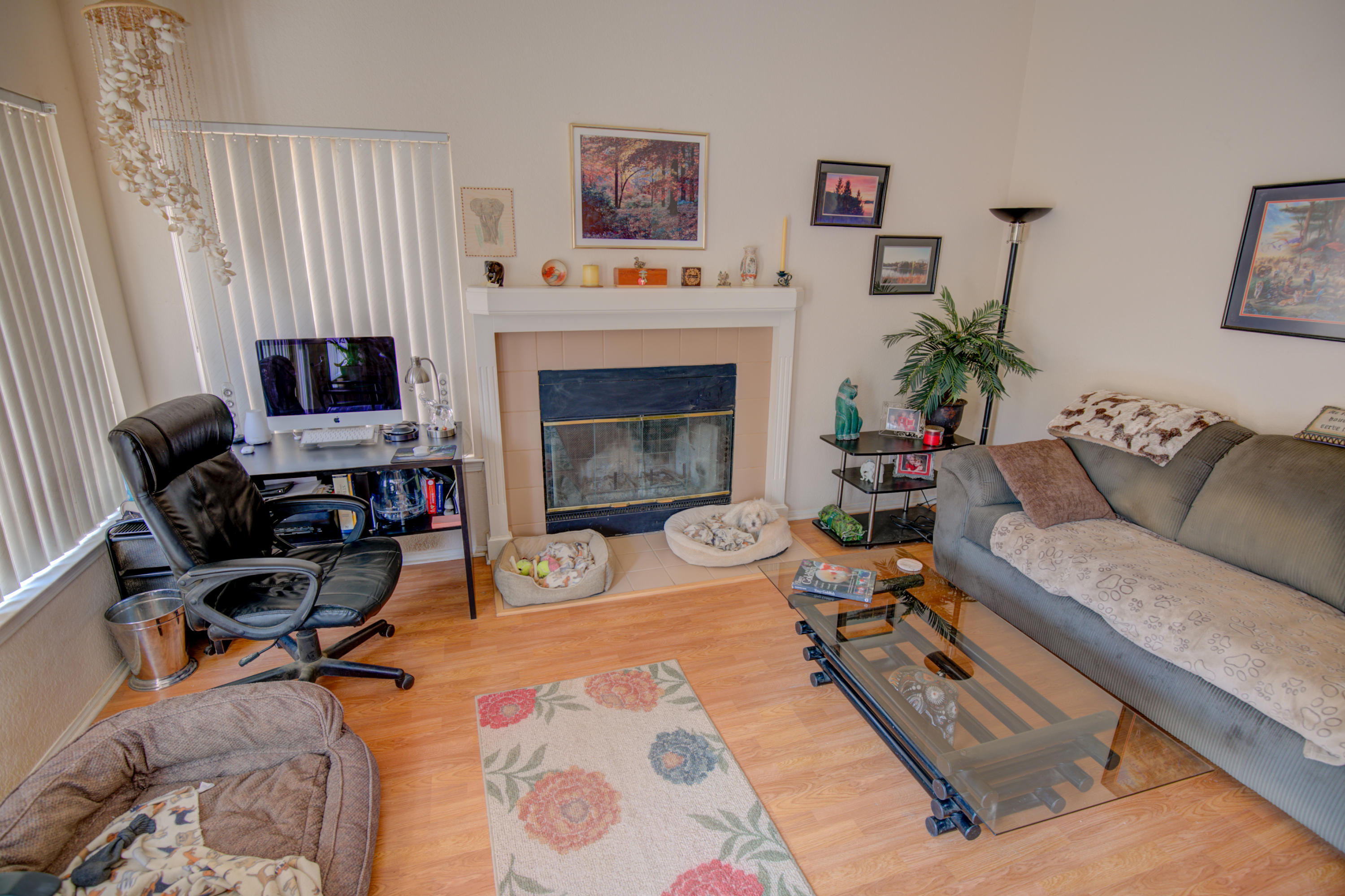 3050 Quarry Road Palmdale, CA 93550 - Photo 5 of 21 a living room with furniture a fireplace and a flat screen tv