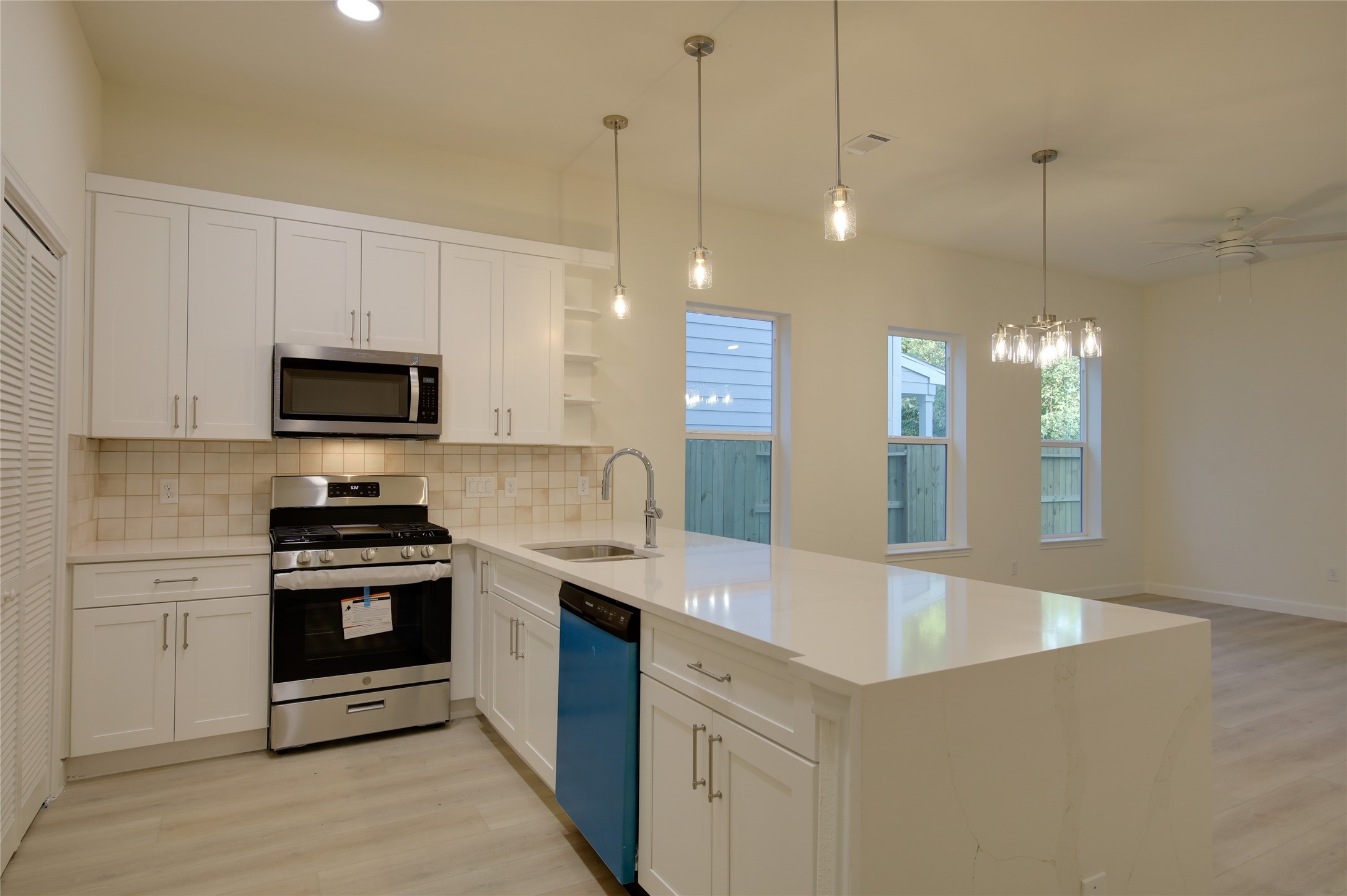 955 Ringold Street Houston, TX 77088 - Photo 11 of 48 a kitchen with a sink stainless steel appliances and white cabinets