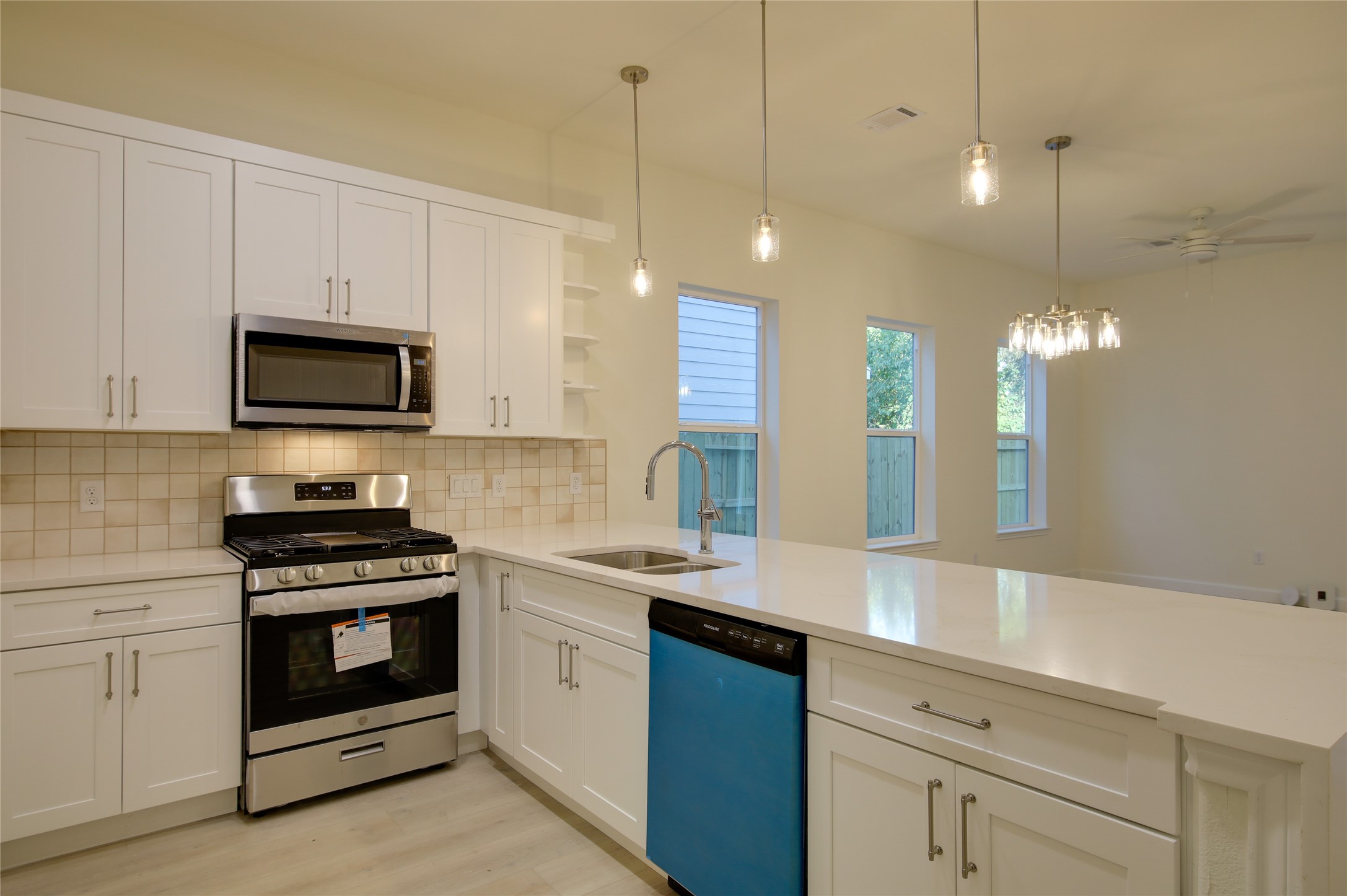 955 Ringold Street Houston, TX 77088 - Photo 12 of 48 a kitchen with a sink stove and microwave