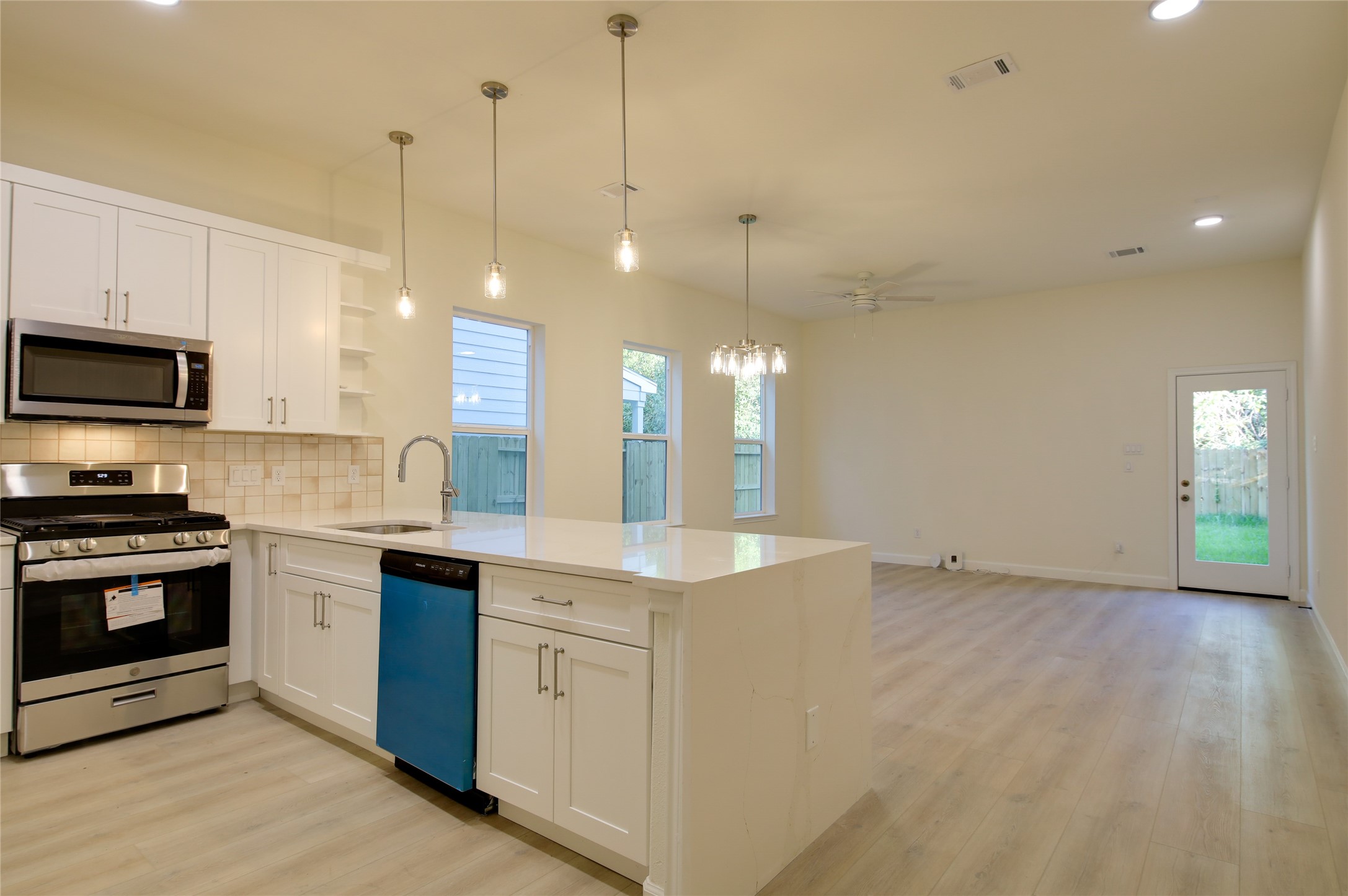 955 Ringold Street Houston, TX 77088 - Photo 14 of 48 a view of a kitchen with a sink and microwave