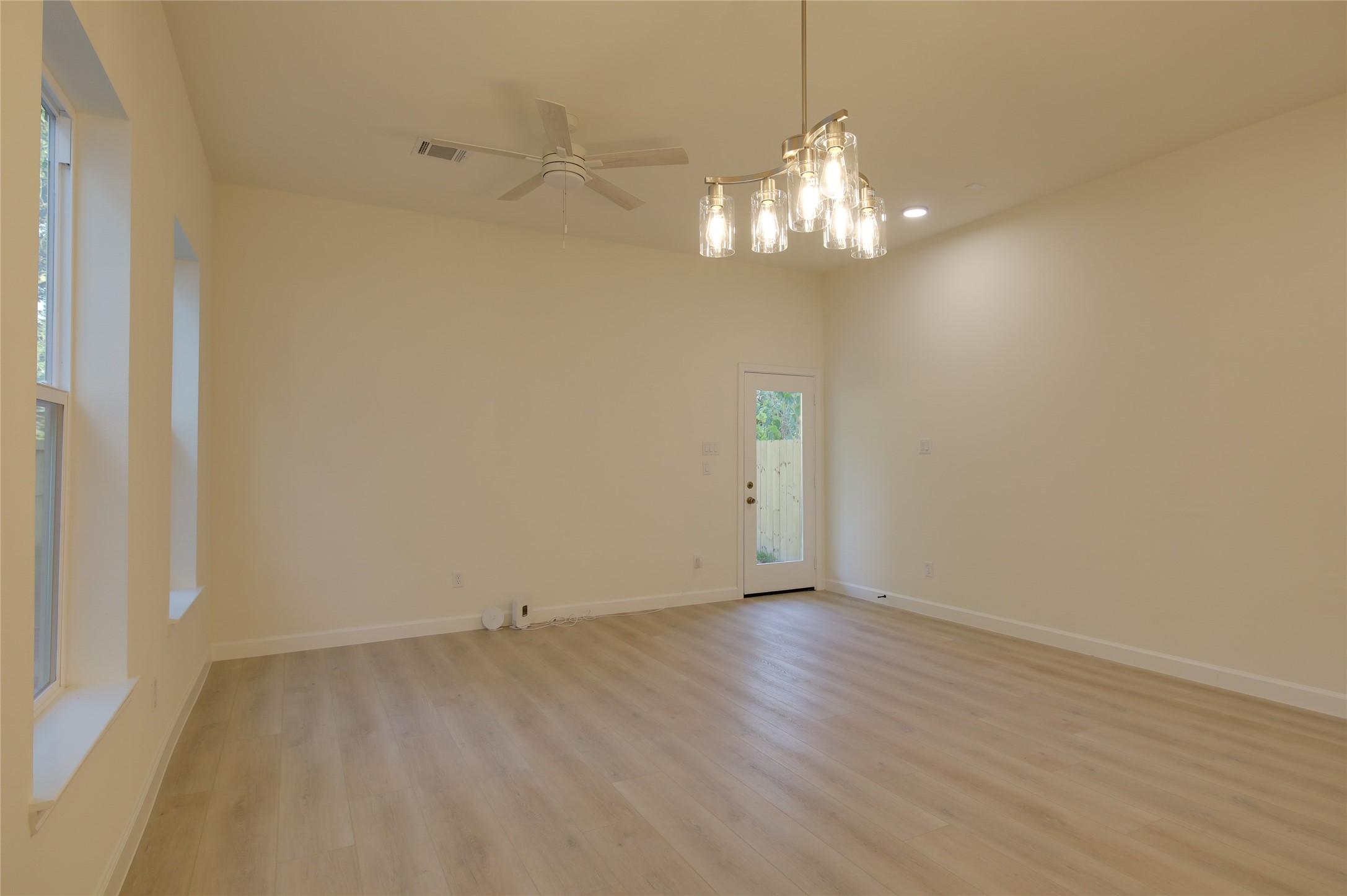 955 Ringold Street Houston, TX 77088 - Photo 16 of 48 a view of a chandelier in big room with wooden floor