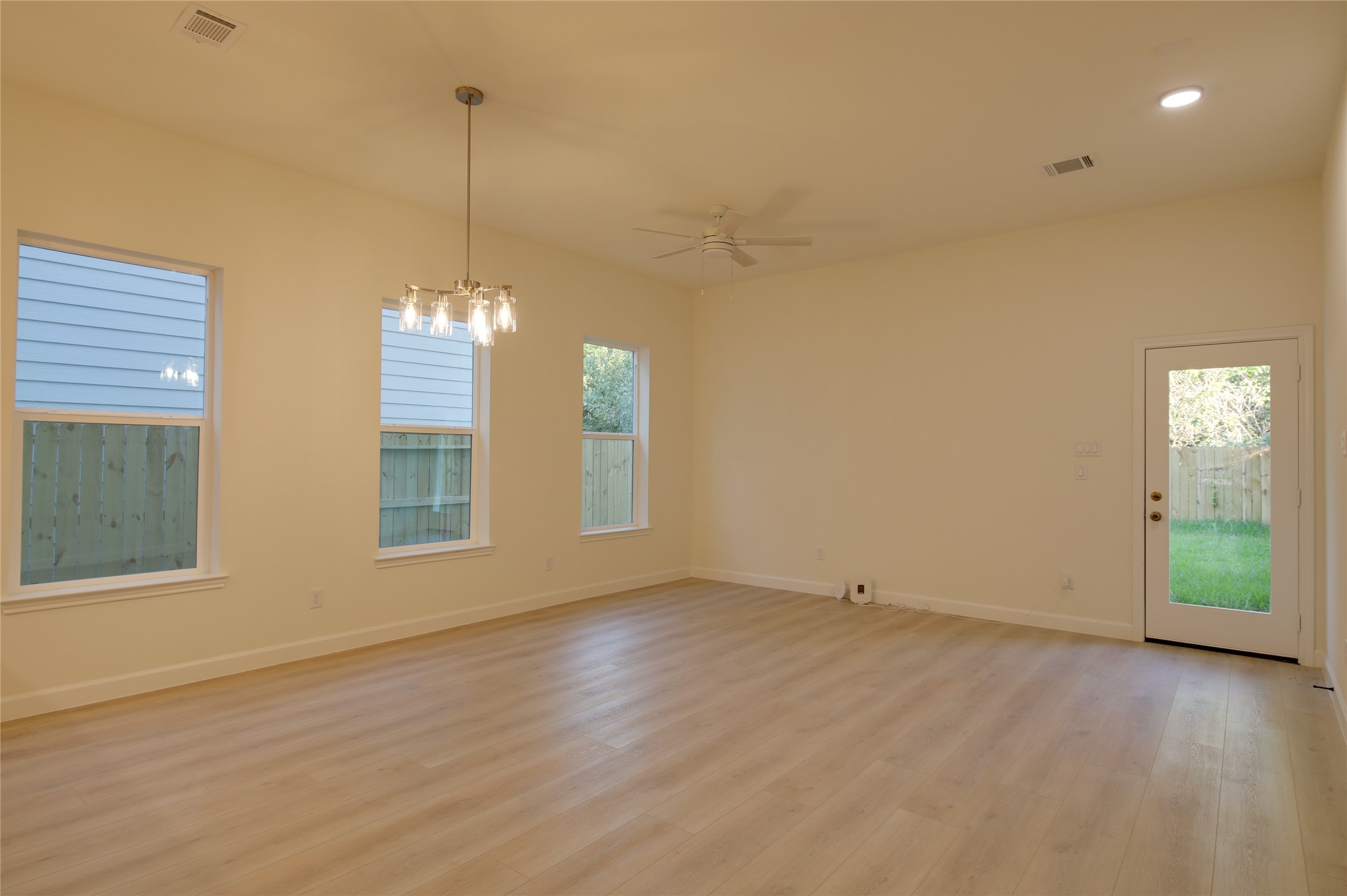955 Ringold Street Houston, TX 77088 - Photo 17 of 48 a view of empty room with wooden floor and fan