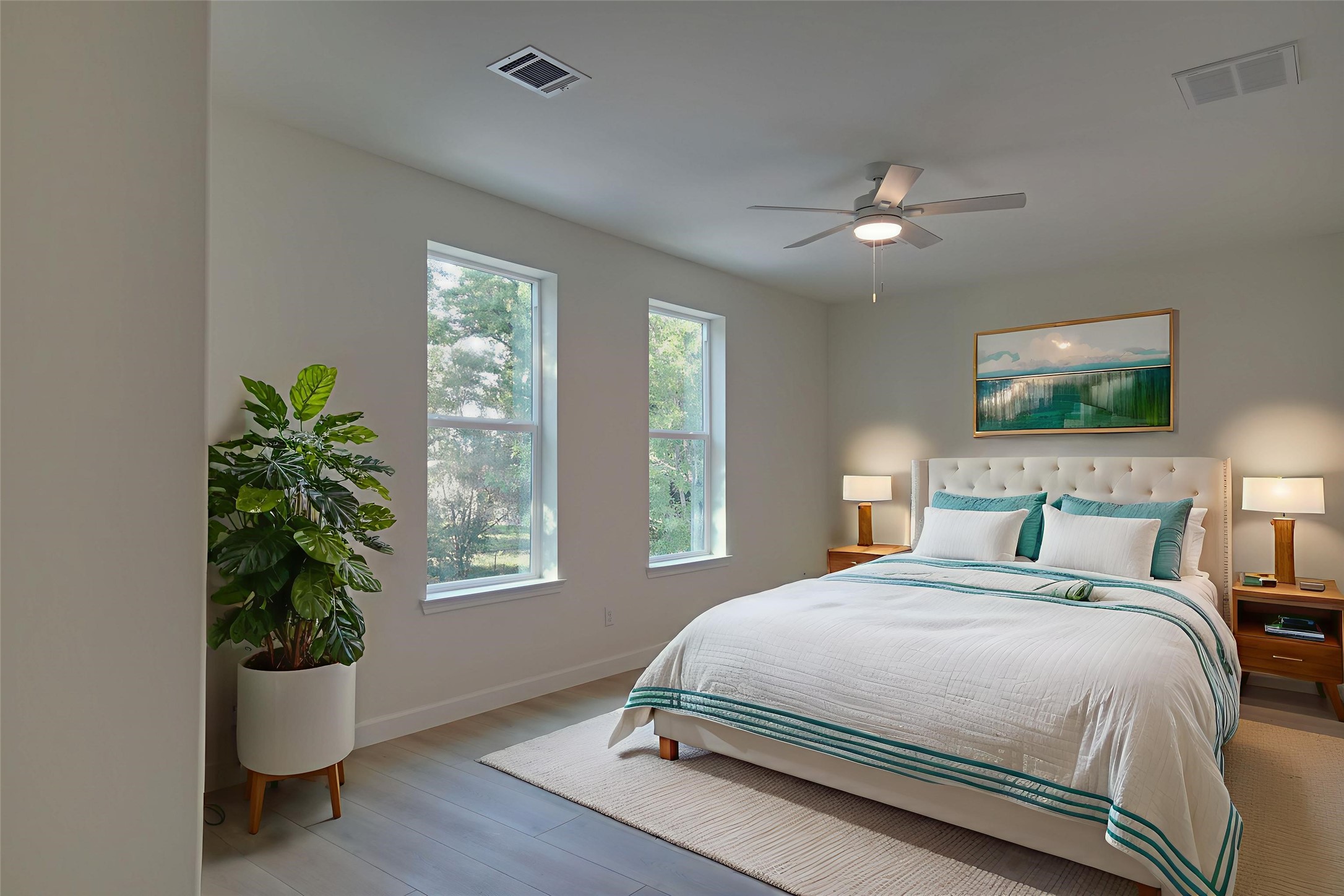 955 Ringold Street Houston, TX 77088 - Photo 25 of 48 a bedroom with a large bed and a potted plant