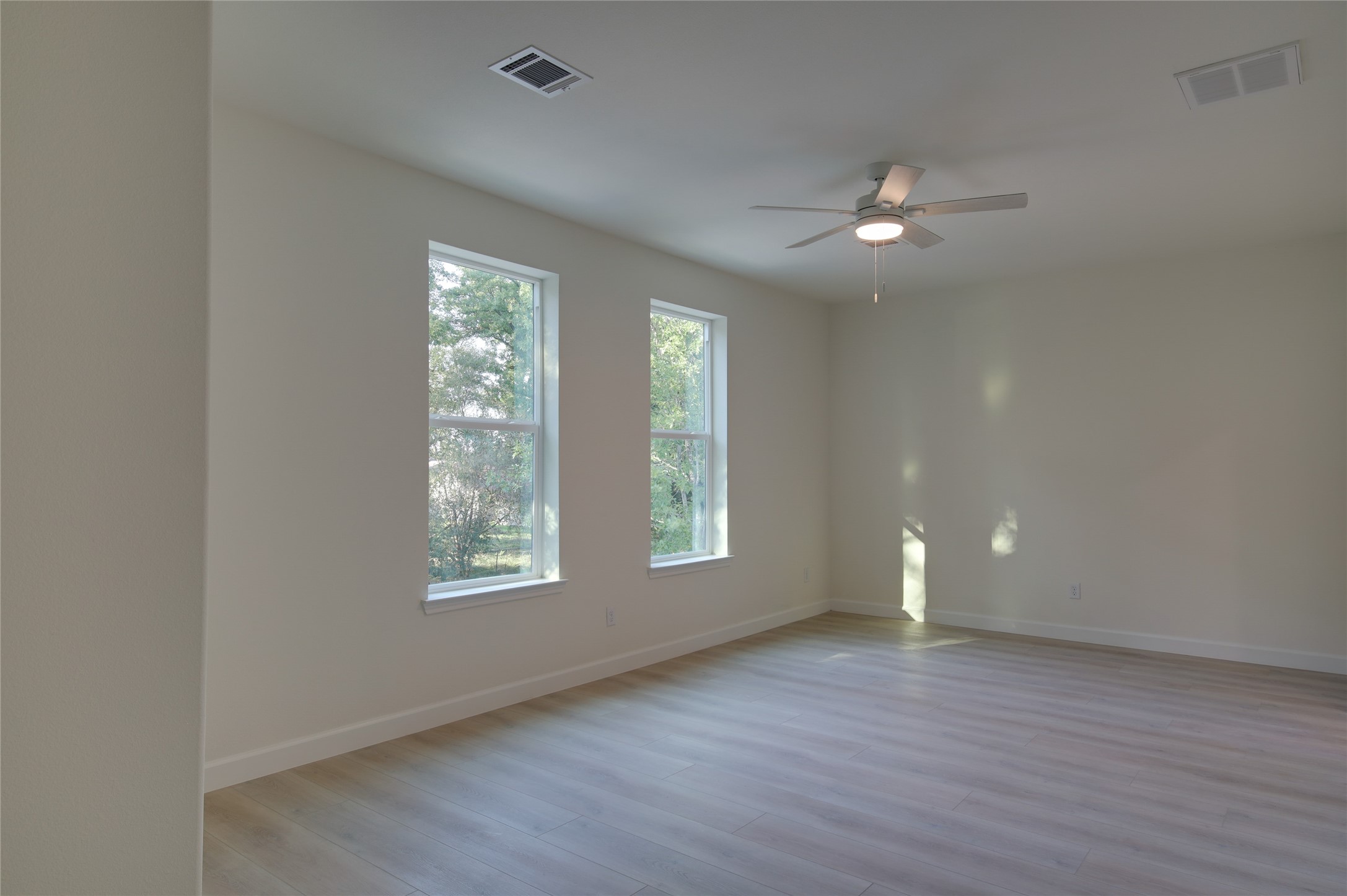 955 Ringold Street Houston, TX 77088 - Photo 26 of 48 a view of an empty room with a window and wooden floor