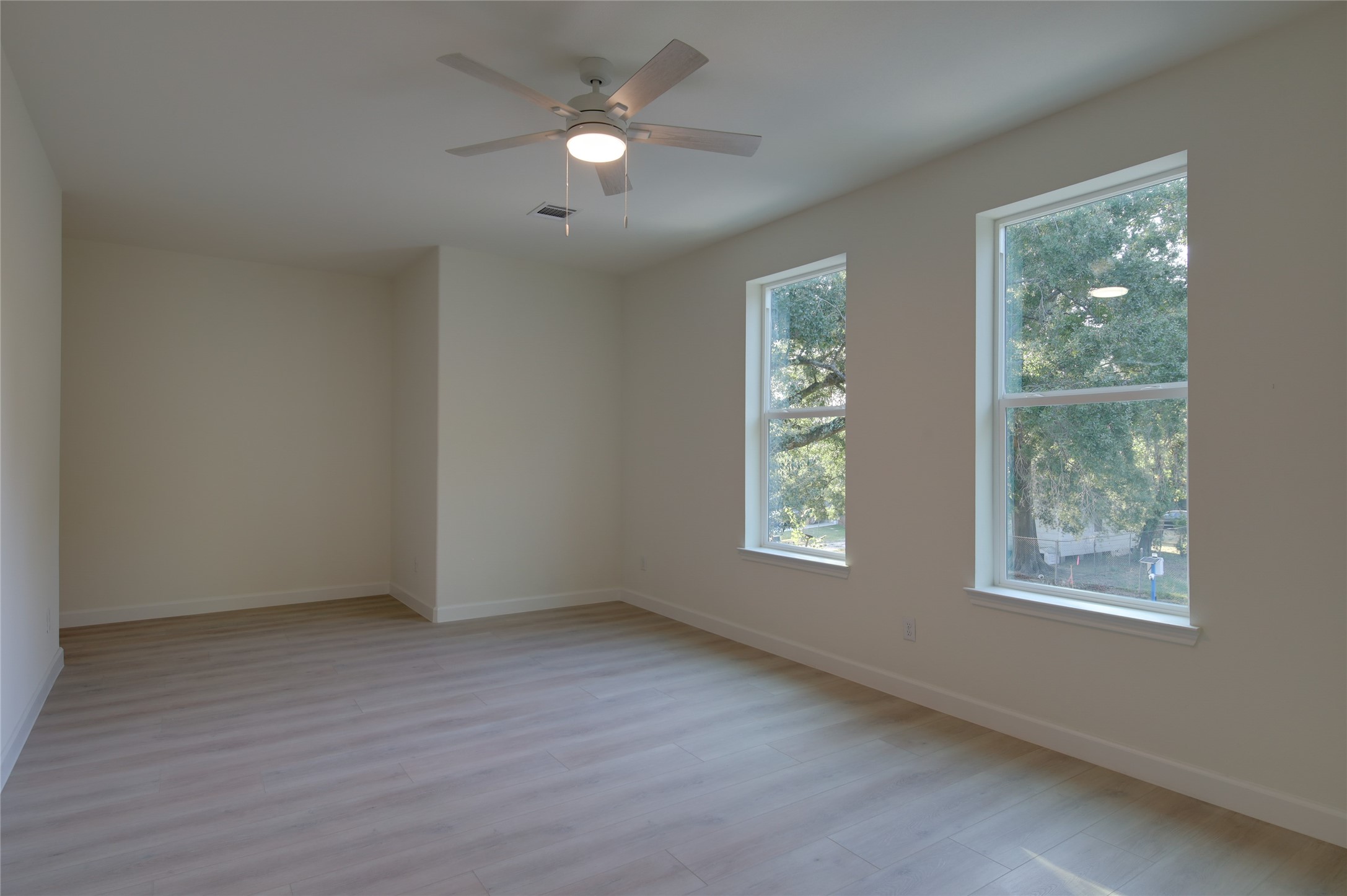 955 Ringold Street Houston, TX 77088 - Photo 33 of 48 a view of an empty room with a window and wooden floor