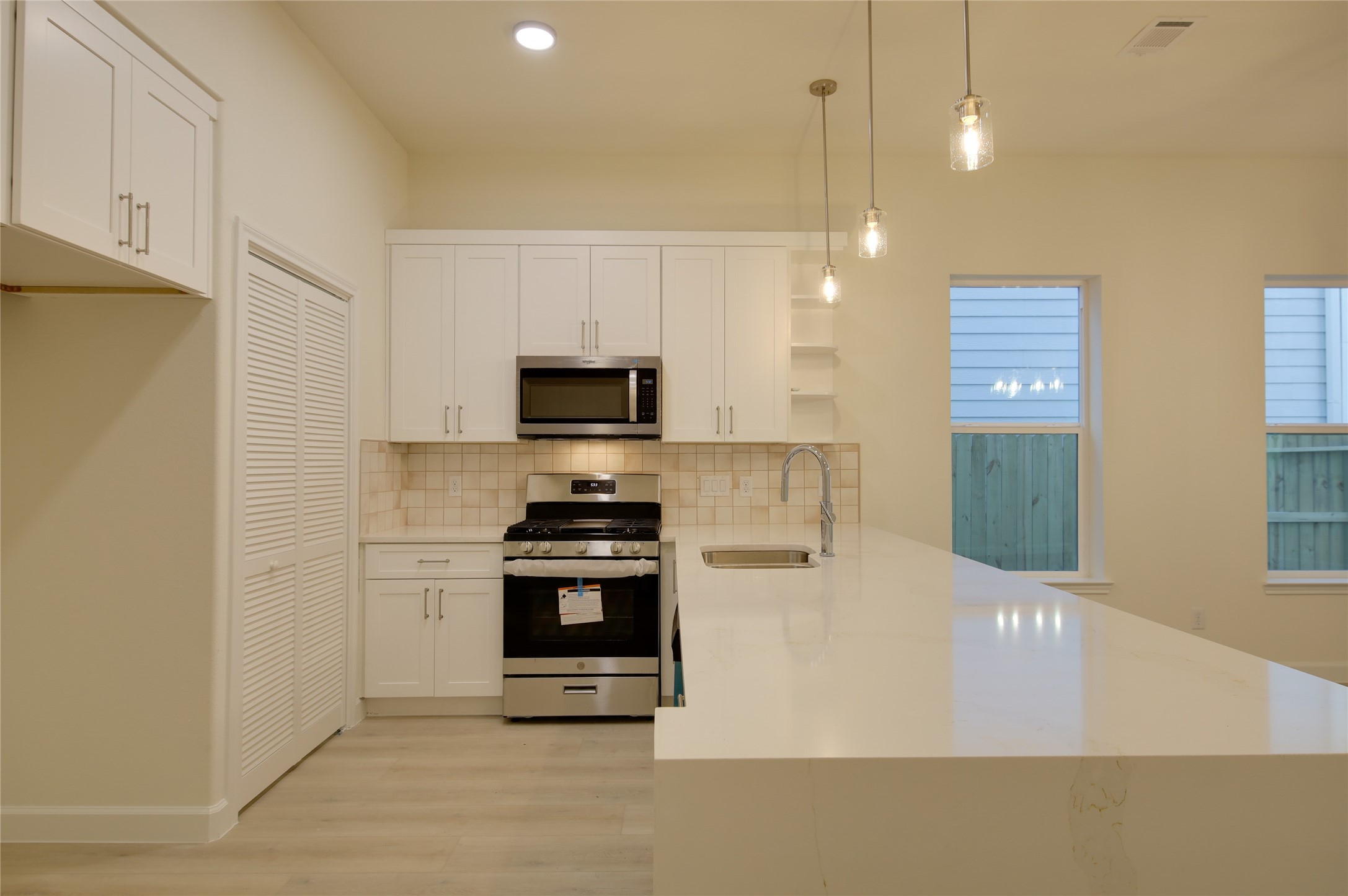 955 Ringold Street Houston, TX 77088 - Photo 10 of 48 a kitchen with stainless steel appliances a stove a microwave and a refrigerator