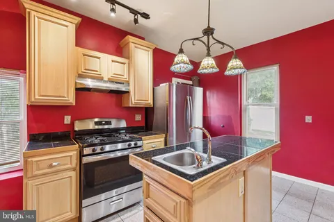 a kitchen with stainless steel appliances granite countertop a stove a refrigerator and a microwave