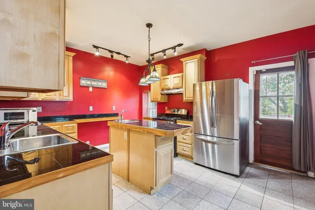 a kitchen with cabinets and stainless steel appliances