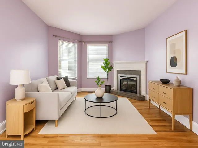 a living room with furniture a window and a fireplace