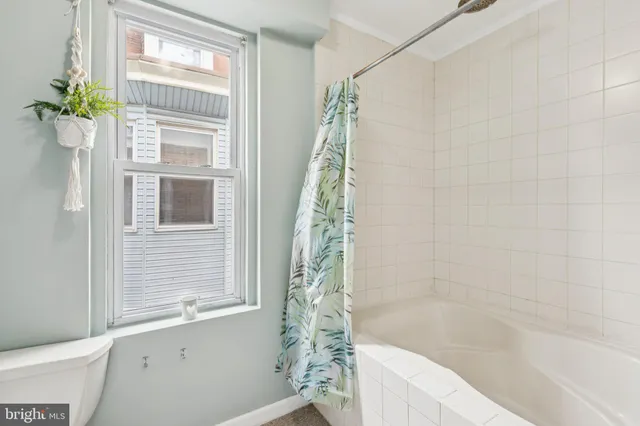 a bathroom with a bathtub and shower