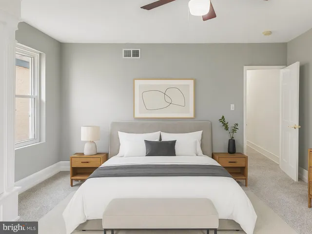 a bedroom with a bed and a window