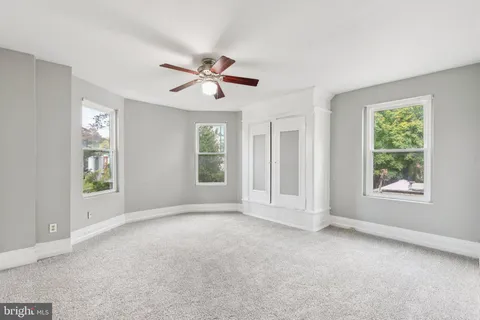 a view of room with a ceiling fan and window