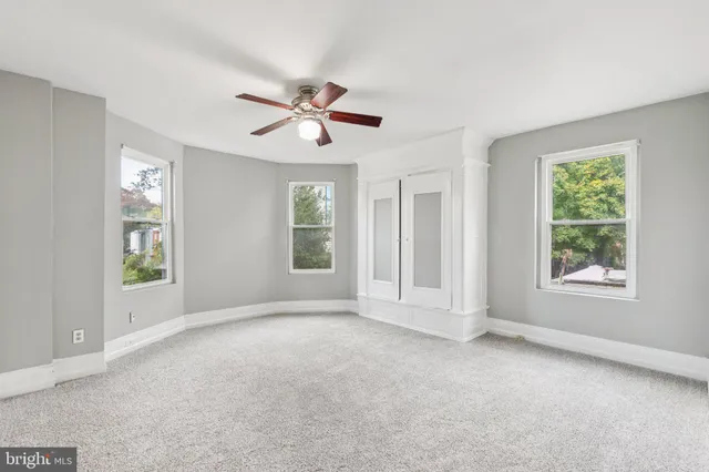 a view of room with a ceiling fan and window
