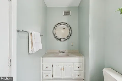 a bathroom with a granite countertop sink mirror and vanity