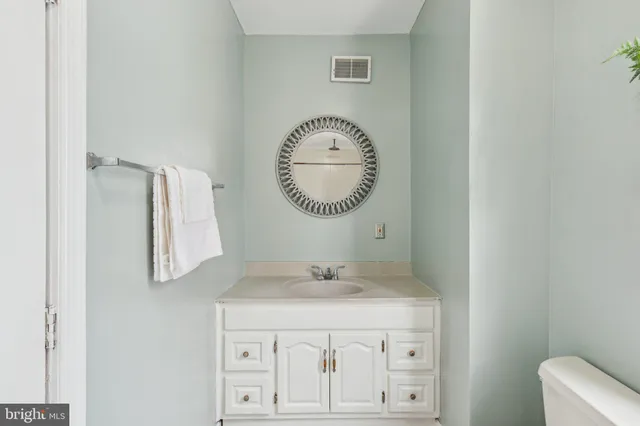 a bathroom with a granite countertop sink mirror and vanity