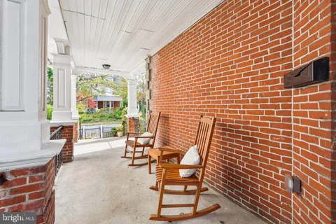 a view of a patio with table and chairs and potted plants