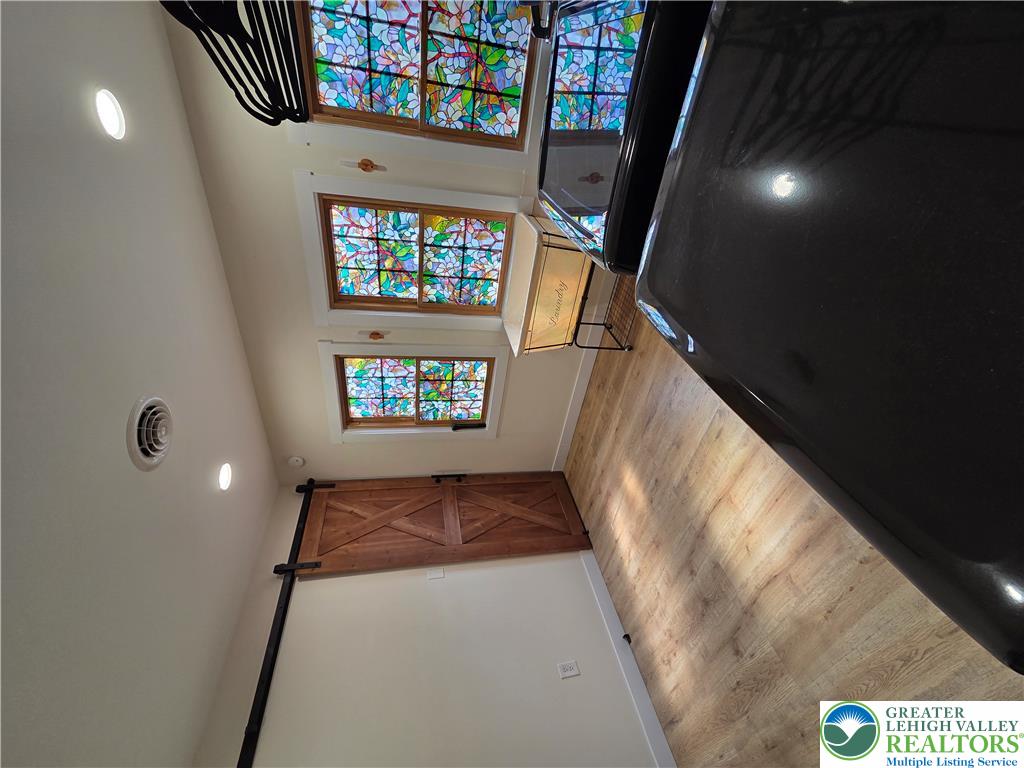 89 Short Ridge Road Albrightsville, PA 18210 - Photo 46 of 71 A sliding barn door and stained glass windows bring character to this functional laundry space.