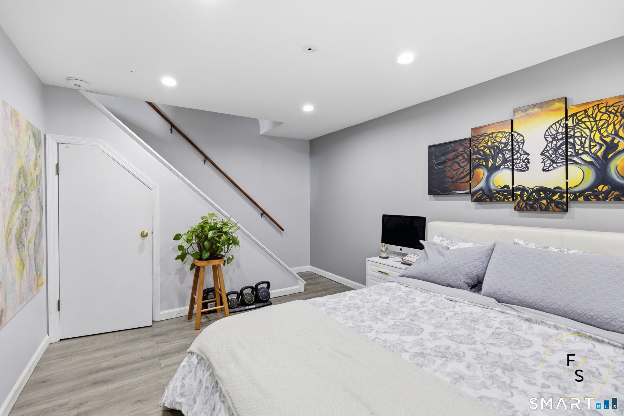 1 Phillips Street, Unit 4 Norwalk, CT 06850 - Photo 21 of 35 a bedroom with a bed and potted plants with wooden floor