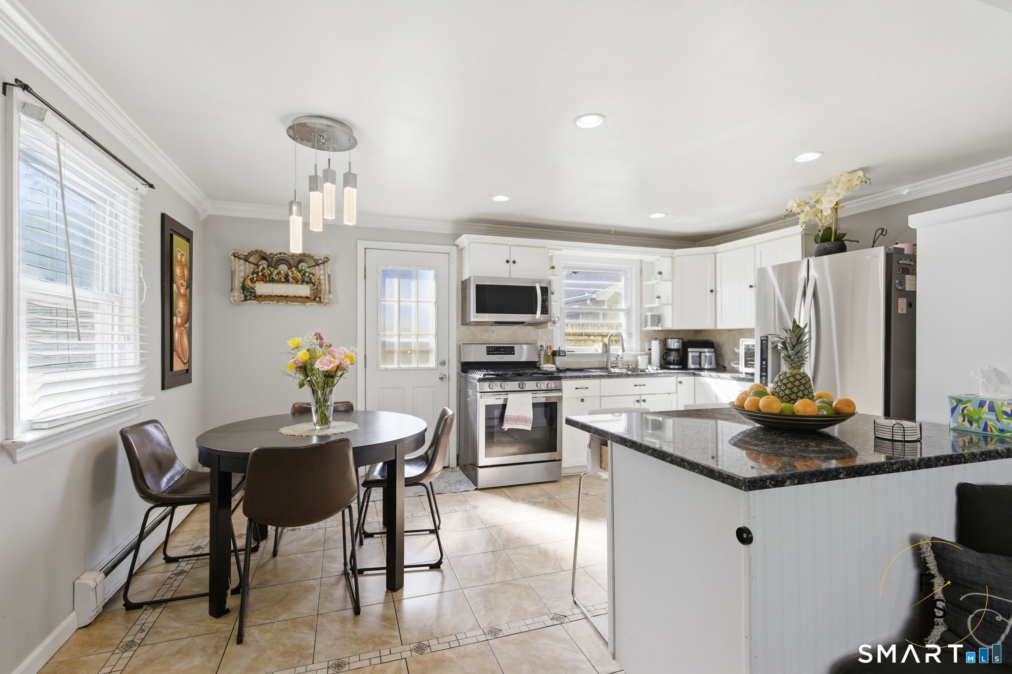 1 Phillips Street, Unit 4 Norwalk, CT 06850 - Photo 4 of 35 a kitchen with refrigerator and chairs