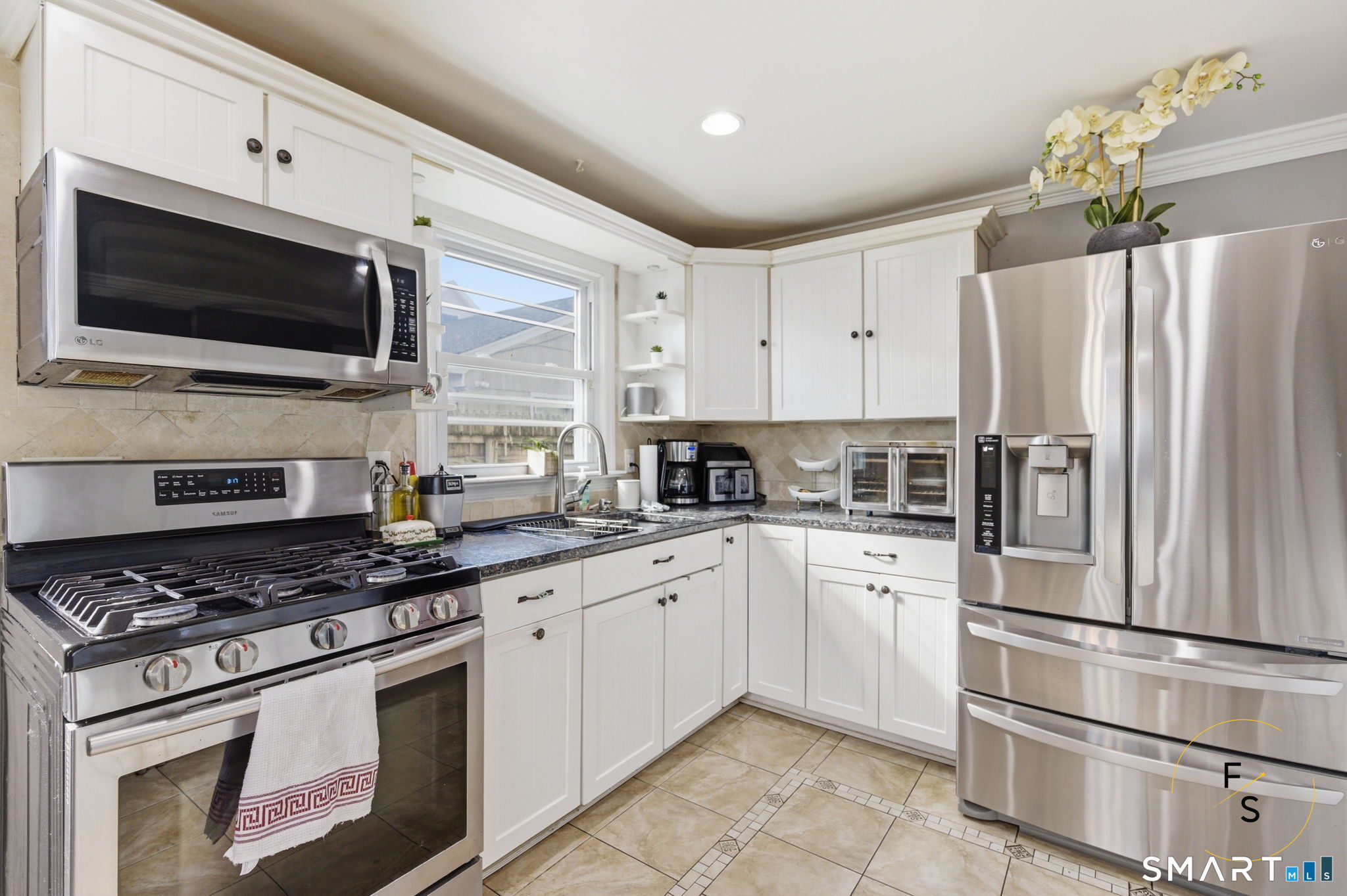1 Phillips Street, Unit 4 Norwalk, CT 06850 - Photo 9 of 35 a kitchen with stainless steel appliances white cabinets a stove top oven a sink and dishwasher