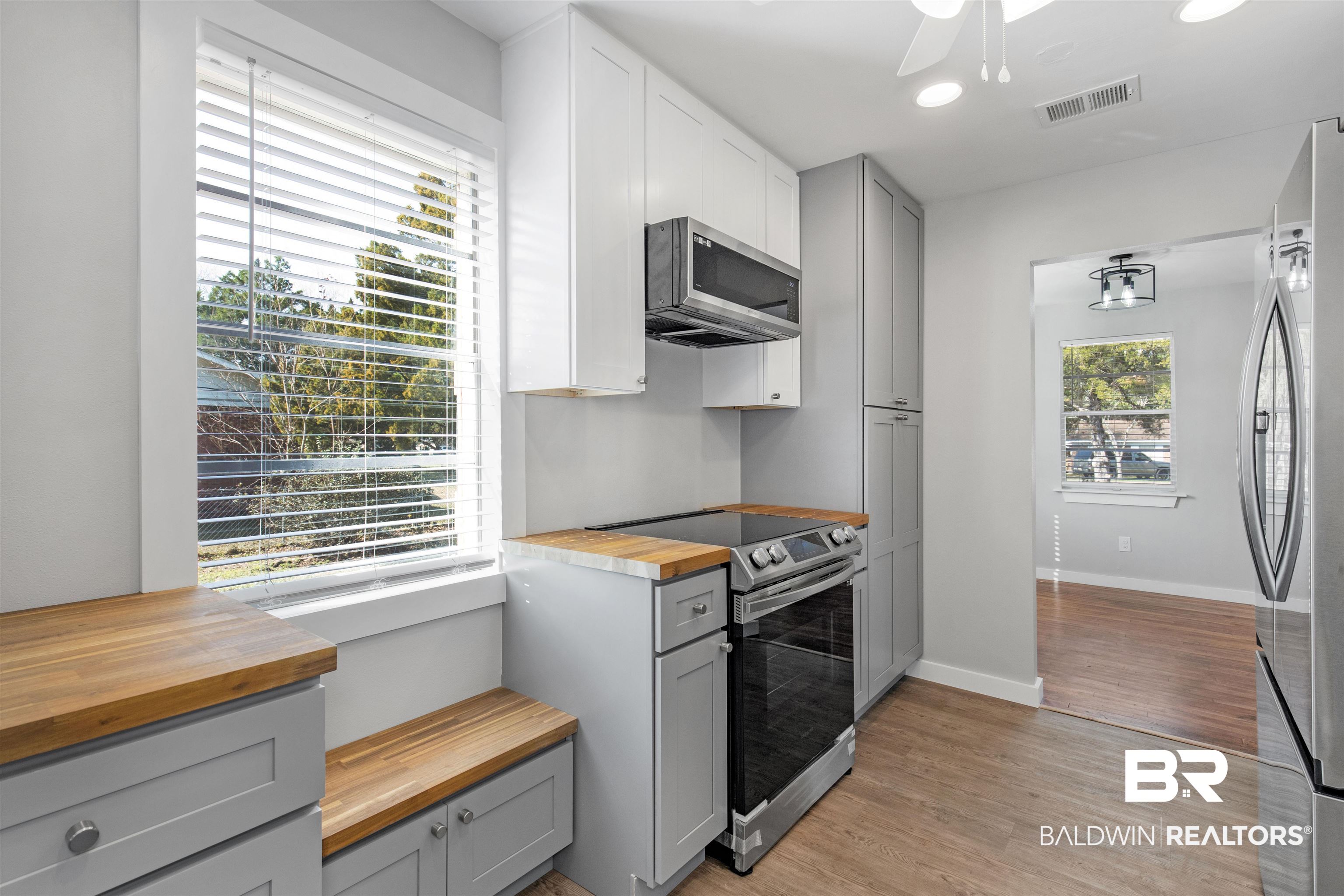 3005 Club House Road Mobile, AL 36605 - Photo 9 of 20 Kitchen featuring wooden counters, stainless steel appliances, gray cabinetry, and light hardwood / wood-style floors