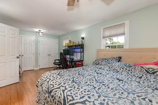 a bed sitting in a room next to a window