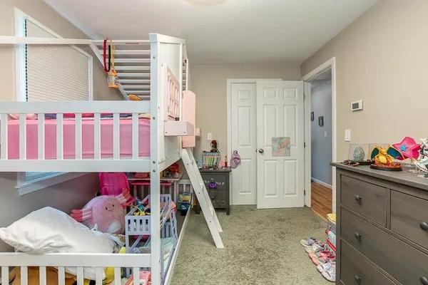 a bedroom with furniture and workout equipment