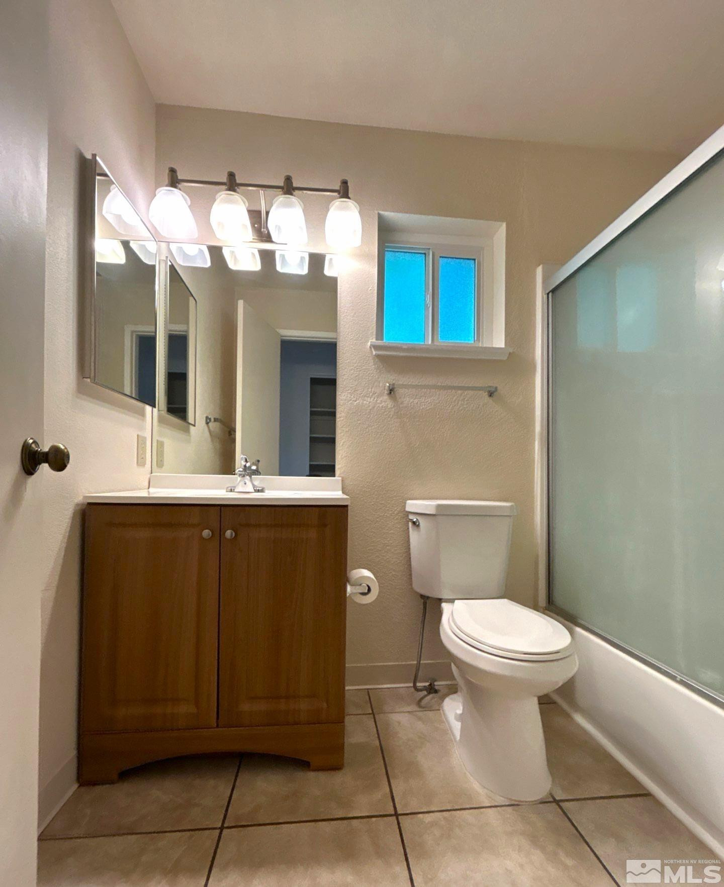 3673 Grant Drive, Unit C Reno, NV 89509 - Photo 13 of 15 a bathroom with a toilet sink and mirror