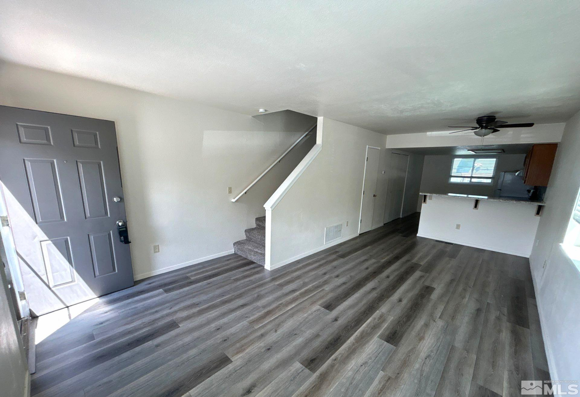 3673 Grant Drive, Unit C Reno, NV 89509 - Photo 7 of 15 a view of a livingroom with wooden floor and staircase