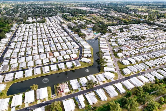 an aerial view of residential houses with city view