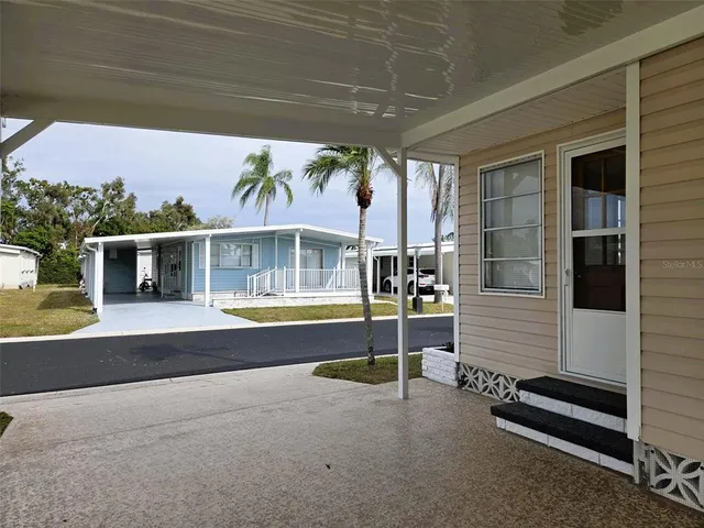 a view of swimming pool with a table and chairs under an umbrella